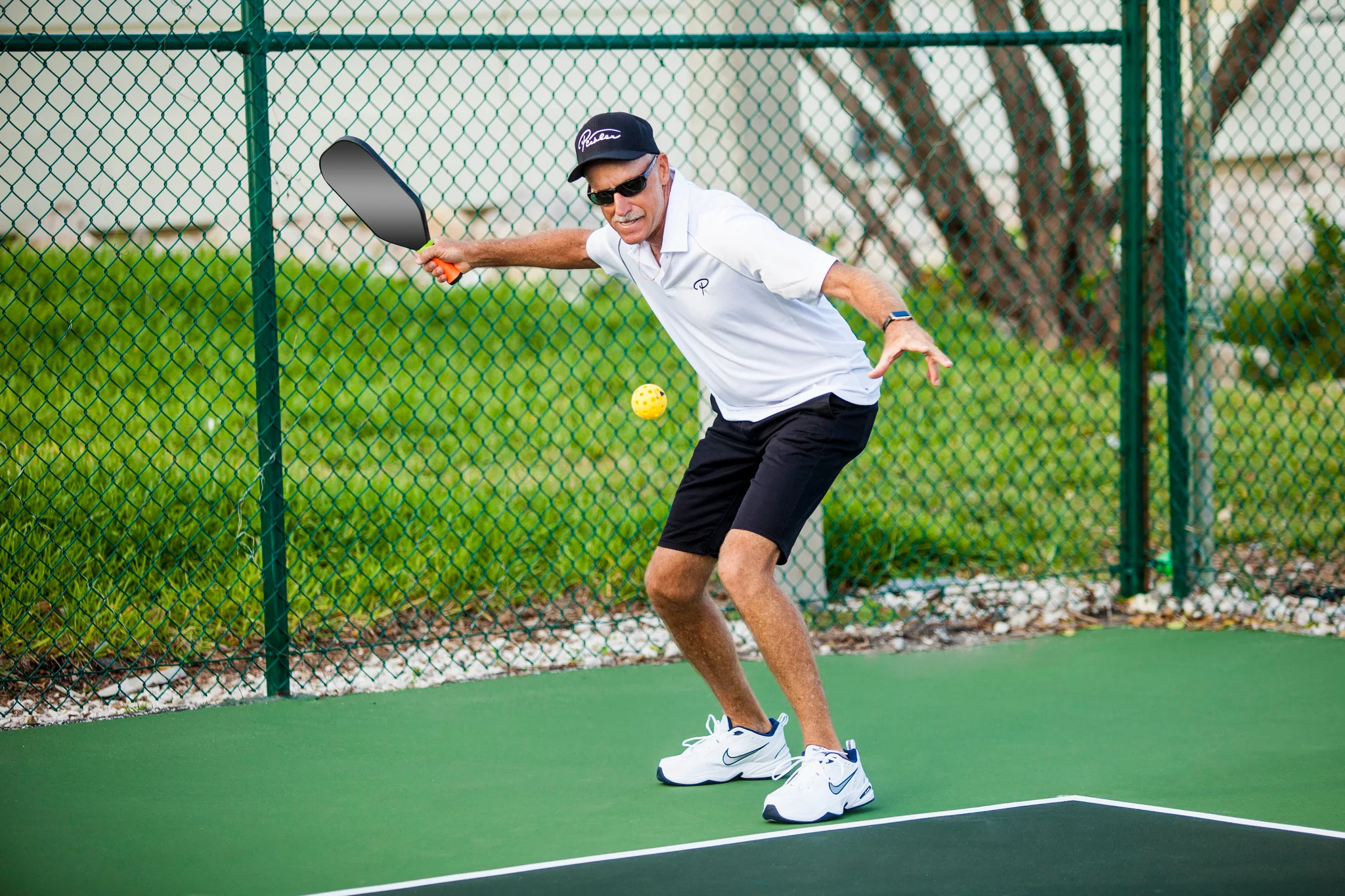 Guy serving pickleball