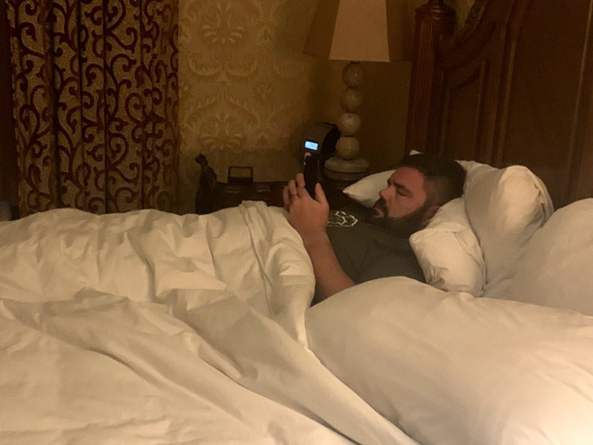 tired husband in hotel room