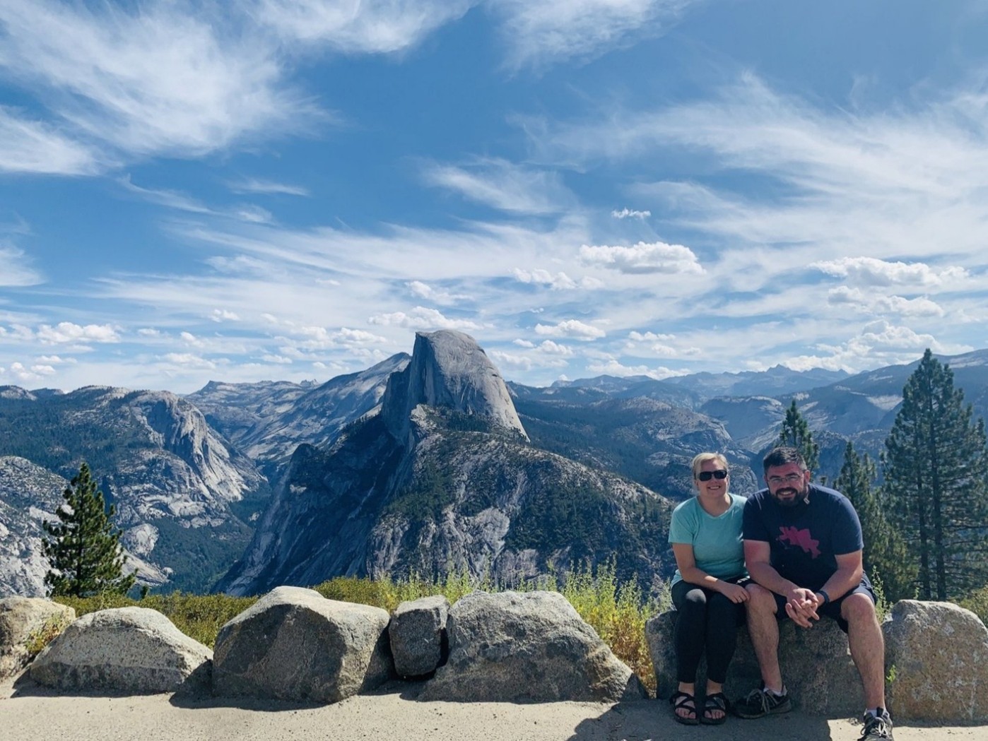 Morgan and her husband sitting in front of some mountains